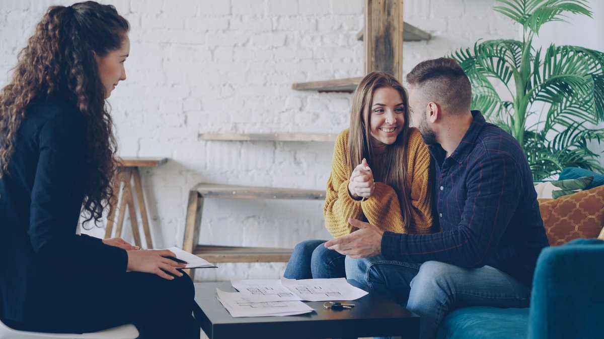 Couple meeting with a financial advisor to review a retirement plan