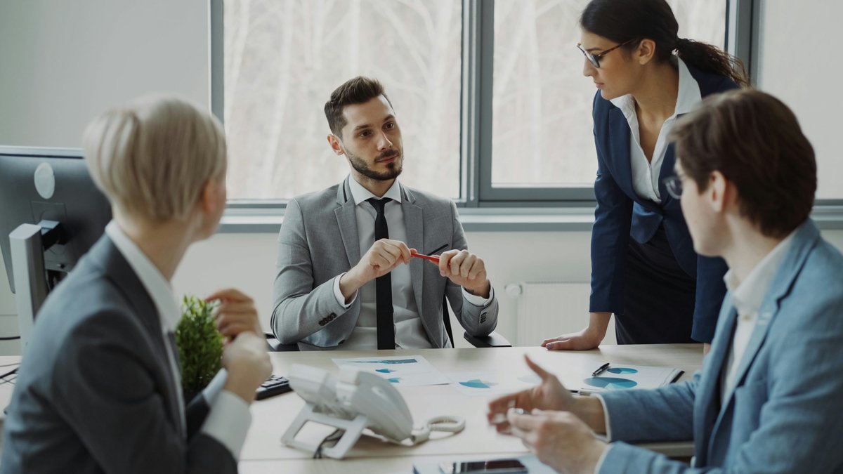 Financial professionals discussing plans around a conference table