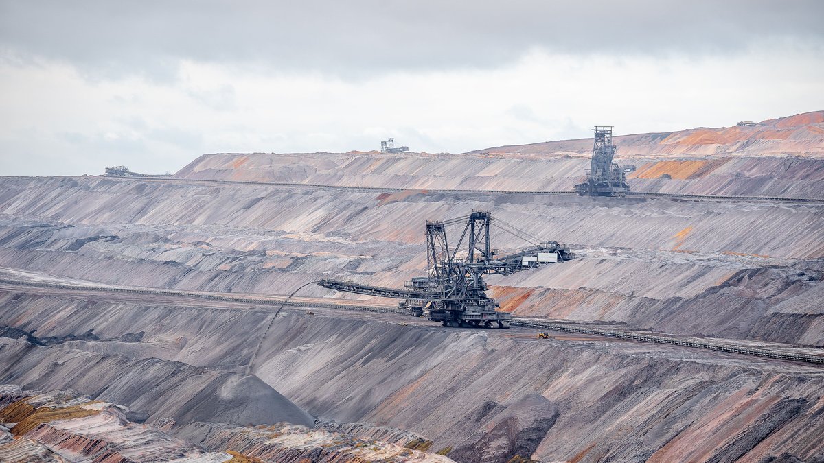 Bucket-wheel excavators in an open-pit coal mine illustrating the energy and infrastructure intensity of mining operations