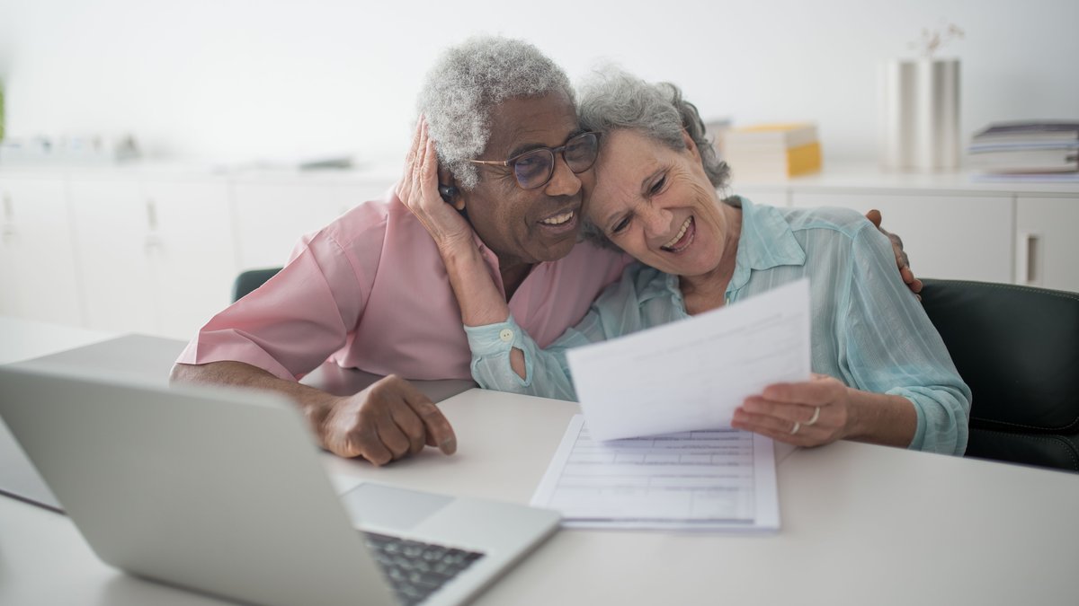 Senior couple reviewing retirement planning documents at home