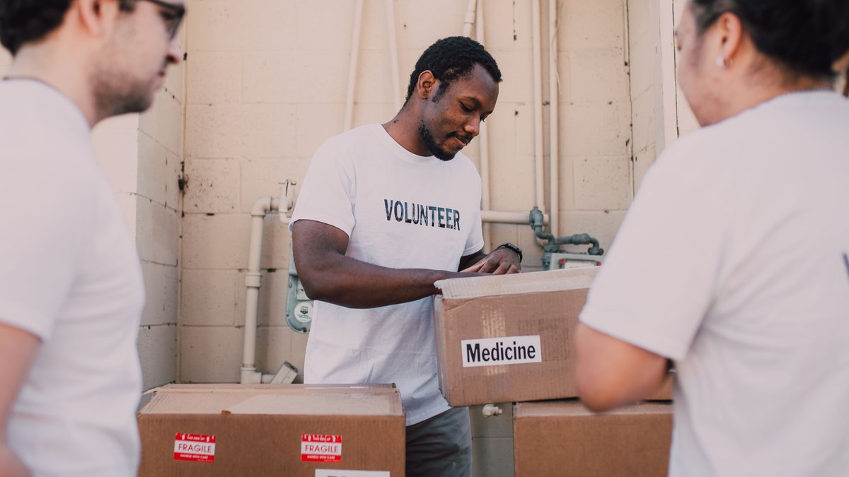Volunteers organizing donated supplies for community charitable aid